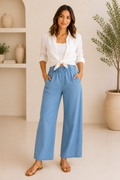Women's sky-blue chambray trousers featuring a comfortable elastic waistband, relaxed wide-leg silhouette, and lightweight casual fabric.